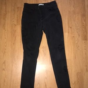 Women’s distressed black skinny jeans
